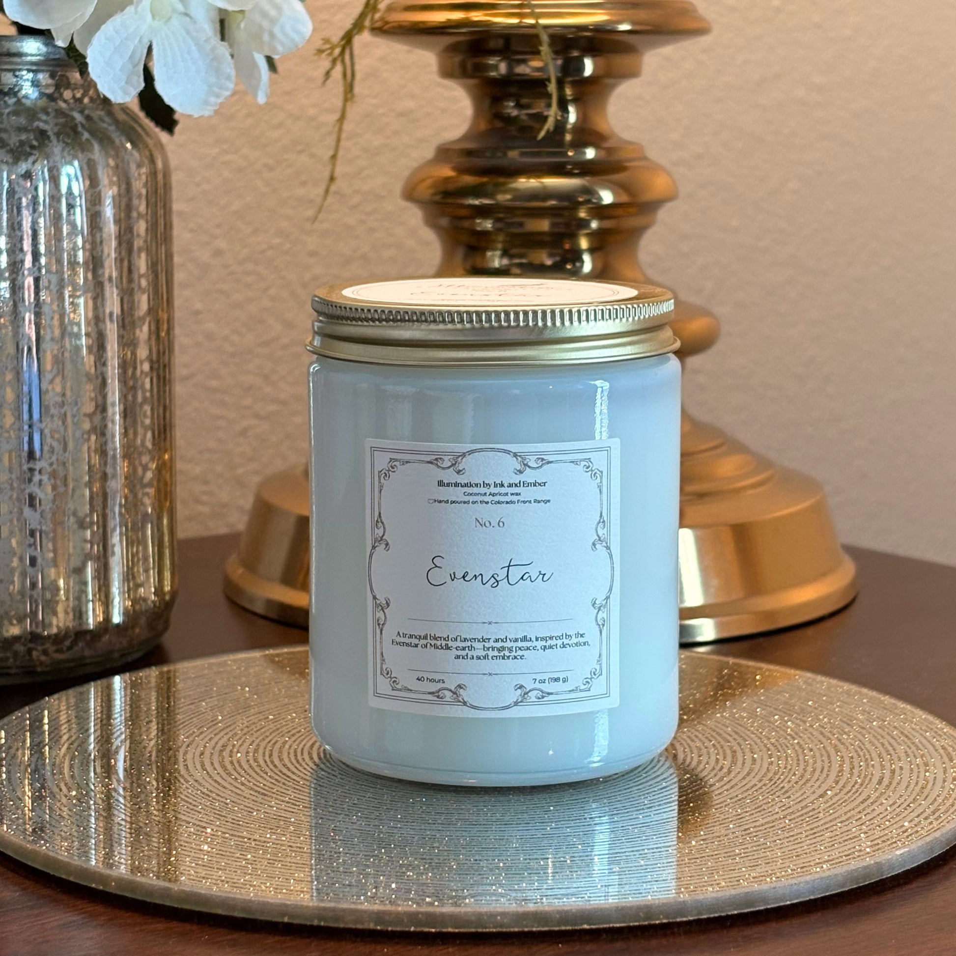 Close-up of Evenstar No. 6 lavender and vanilla scented candle label by Illumination by Ink and Ember, displayed on a gold tray