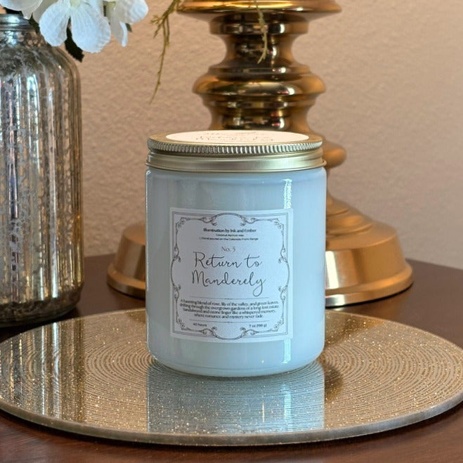 Return to Manderley No. 5 scented candle by Illumination by Ink and Ember, styled on gold tray